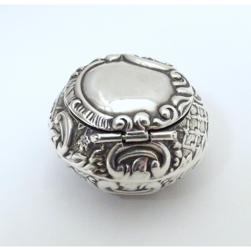 291 - A silver pill box with embossed decoration, hallmarked Birmingham 1904, maker Adie Lovekin Ltd. Appr... 