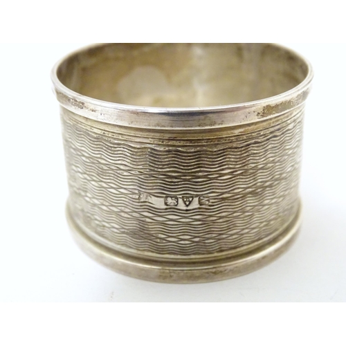 295 - Two silver napkin rings, one hallmarked Birmingham 1947, maker B & Co., the other hallmarked Chester... 