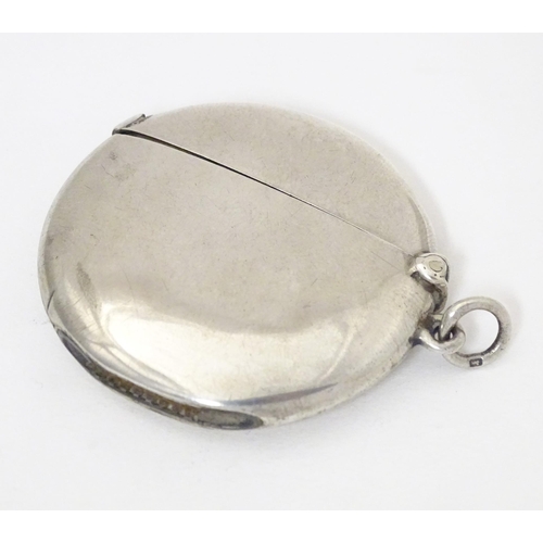 297 - A silver vesta case of circular form, hallmarked Birmingham 1914, maker William Neale & Son Ltd. App... 