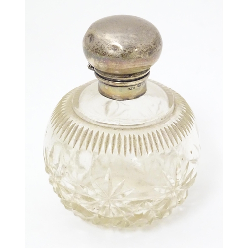 430 - A cut glass scent bottle of spherical form with silver top hallmarked Chester 1921, maker William Va... 