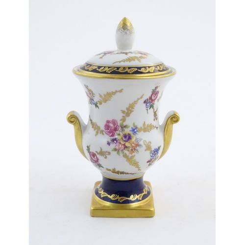 104 - A 20thC German vase and cover decorated with floral and foliate detail with gilt detail. Bearing mar... 