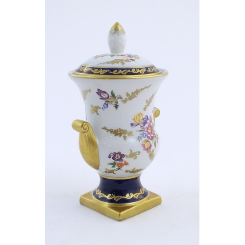 104 - A 20thC German vase and cover decorated with floral and foliate detail with gilt detail. Bearing mar... 