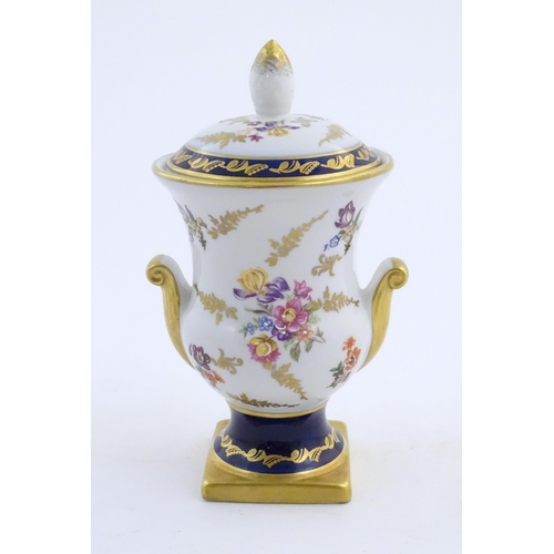 104 - A 20thC German vase and cover decorated with floral and foliate detail with gilt detail. Bearing mar... 