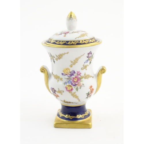 104 - A 20thC German vase and cover decorated with floral and foliate detail with gilt detail. Bearing mar... 