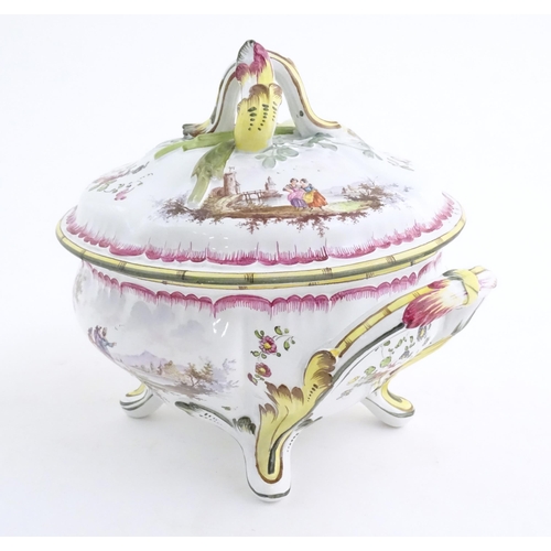 108 - A French lidded tureen with foliate formed handles and standing on four out swept feet, the lid with... 