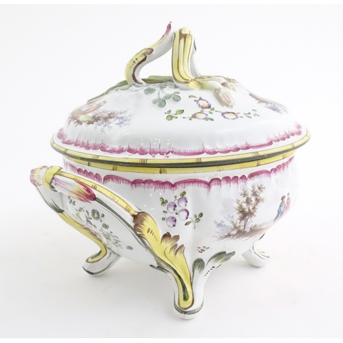 108 - A French lidded tureen with foliate formed handles and standing on four out swept feet, the lid with... 