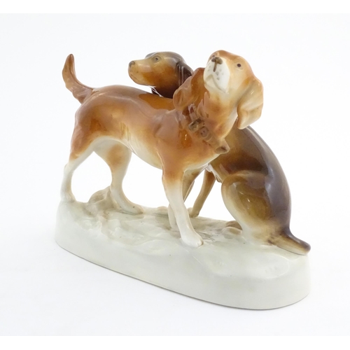 110 - A 20thC Royal Dux model of two dogs. Marked under. Approx. 7 3/4