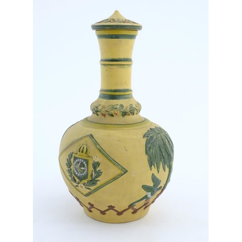 112 - A 19thC lidded bottle vase with relief and polychrome decoration depicting the coat of arms of the E... 