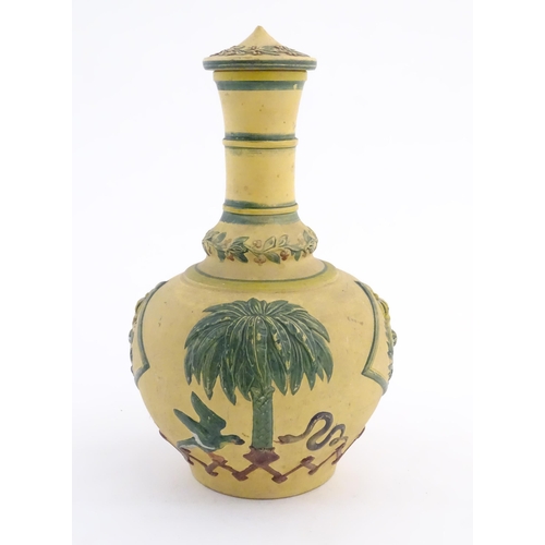 112 - A 19thC lidded bottle vase with relief and polychrome decoration depicting the coat of arms of the E... 