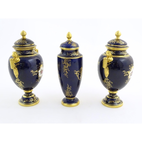 124 - Two Coalport vase and covers with twin handles decorated with hand painted exotic bird vignettes and... 