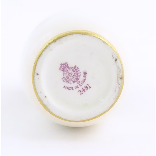 129 - A Royal Worcester vase with floral decoration. Signed Ethel Spilsbury. Marked under. Approx. 5 1/4