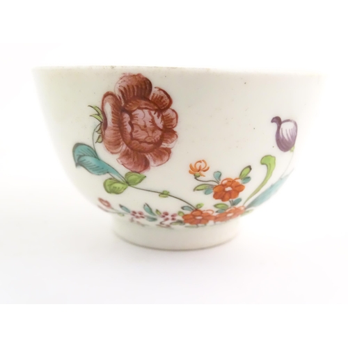 73 - An English late 18th / early 19thC tea bowl and saucer with hand painted floral decoration. In the m... 