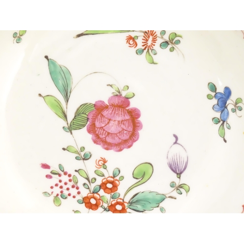 73 - An English late 18th / early 19thC tea bowl and saucer with hand painted floral decoration. In the m... 