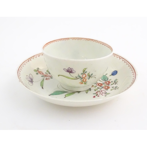 73 - An English late 18th / early 19thC tea bowl and saucer with hand painted floral decoration. In the m... 