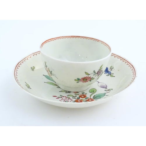 73 - An English late 18th / early 19thC tea bowl and saucer with hand painted floral decoration. In the m... 