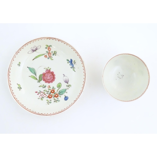 73 - An English late 18th / early 19thC tea bowl and saucer with hand painted floral decoration. In the m... 