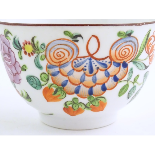 75 - A 19thC English porcelain tea bowl and saucer with hand painted floral and foliate decoration. The s... 