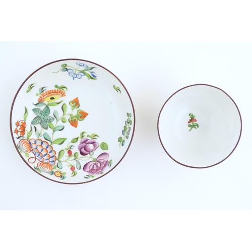 75 - A 19thC English porcelain tea bowl and saucer with hand painted floral and foliate decoration. The s... 