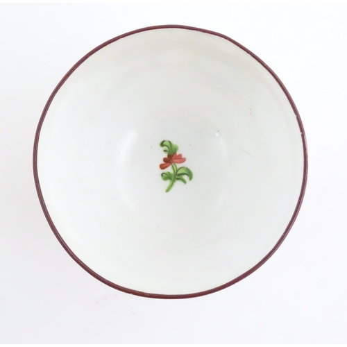 75 - A 19thC English porcelain tea bowl and saucer with hand painted floral and foliate decoration. The s... 