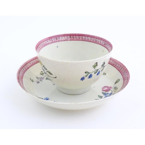 76 - An English late 18th / early 19thC tea bowl and saucer with hand painted floral decoration and a puc... 