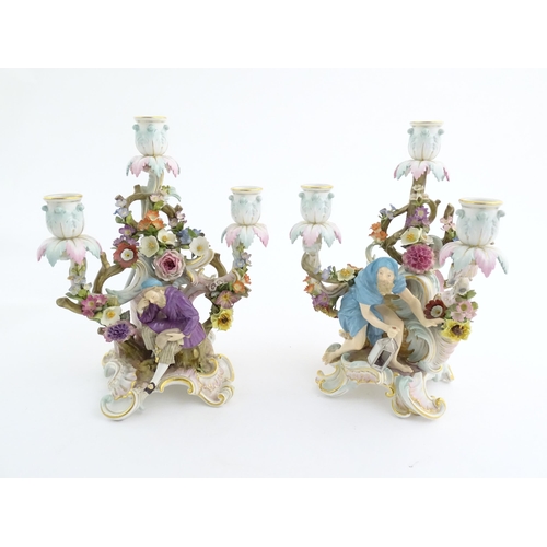 94 - A pair of late 19thC Meissen three branch figural and floral candelabras, one depicting the Greek ph... 