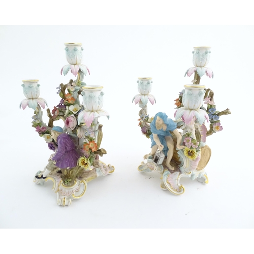 94 - A pair of late 19thC Meissen three branch figural and floral candelabras, one depicting the Greek ph... 