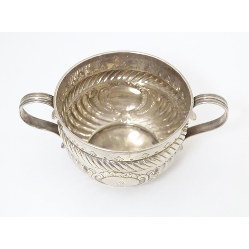 312 - WITHDRAWN FROM AUCTION - Apologies for any inconvenience. A Geo III silver porringer with fluted and... 