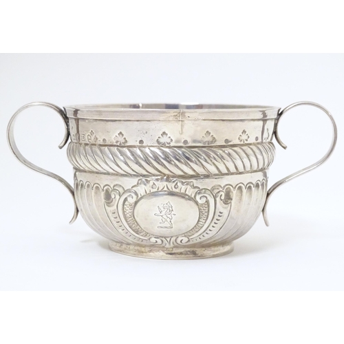 312 - WITHDRAWN FROM AUCTION - Apologies for any inconvenience. A Geo III silver porringer with fluted and... 