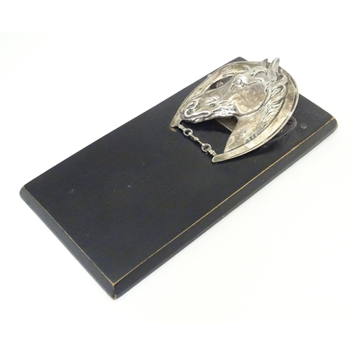 321 - A silver letter / note clip mounted on an ebonised base. The clip modelled as a horse head and horse... 