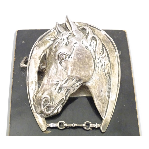 321 - A silver letter / note clip mounted on an ebonised base. The clip modelled as a horse head and horse... 