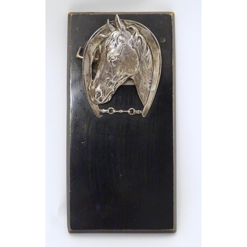 321 - A silver letter / note clip mounted on an ebonised base. The clip modelled as a horse head and horse... 