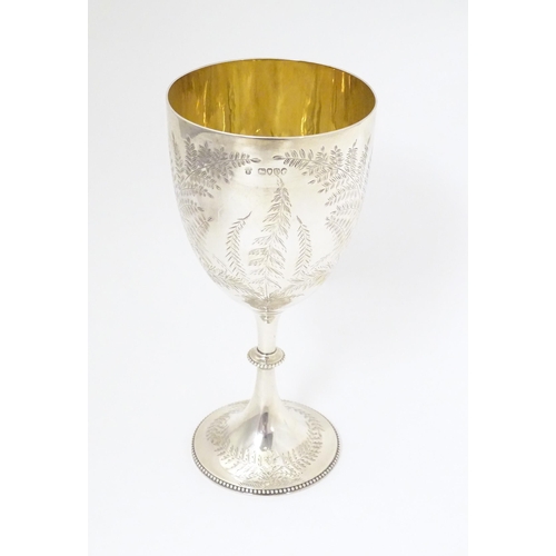 327 - A Victorian silver trophy cup of goblet form with engraved fern detail and gilded interior, hallmark... 