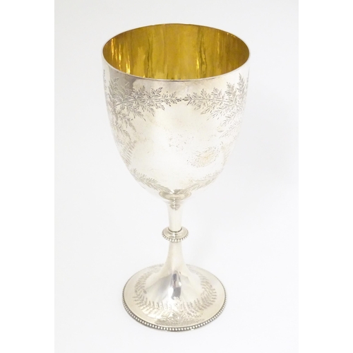 327 - A Victorian silver trophy cup of goblet form with engraved fern detail and gilded interior, hallmark... 