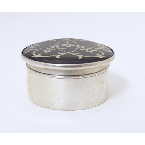 329 - A silver and tortoiseshell pill box with  pique decoration to lid. Hallmarked  London 1912 Approx. 1... 