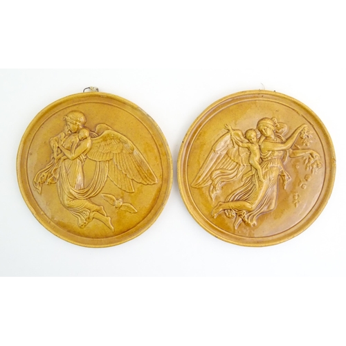 161 - Two Dunmore pottery roundel / plaques depicting a female angel carrying children. One stamped Peter ... 