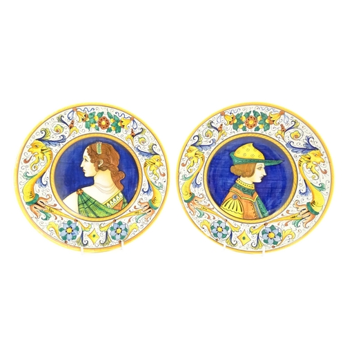 162 - Two Italian majolica portrait plates with folate and mask detail to borders. Signed under S Volpi, D... 