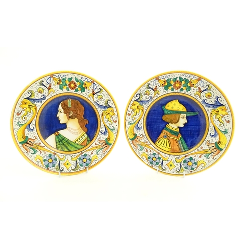 162 - Two Italian majolica portrait plates with folate and mask detail to borders. Signed under S Volpi, D... 