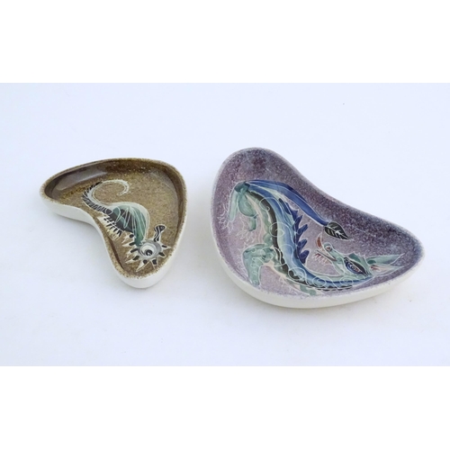 165 - Two studio pottery shaped dishes by Jo Lester, one with seahorse decoration, the other with dragon d... 