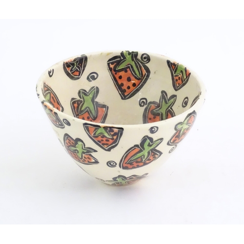 166 - A studio pottery jug and bowl decorated with hand painted strawberry detail by Liz Riley. Marked und... 