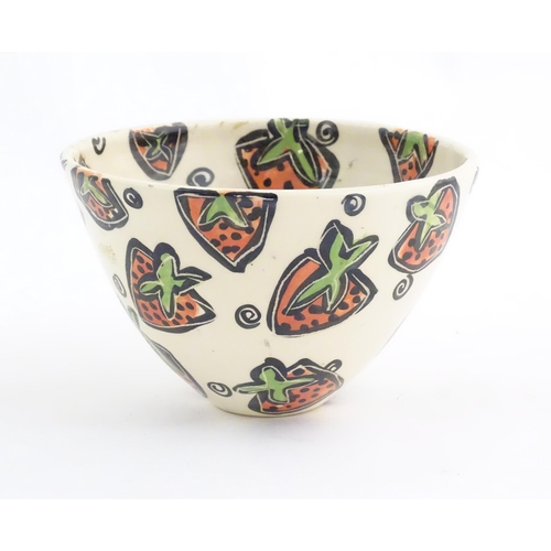 166 - A studio pottery jug and bowl decorated with hand painted strawberry detail by Liz Riley. Marked und... 