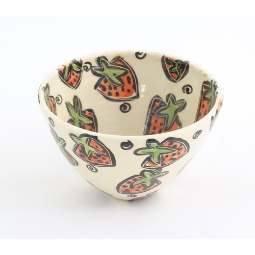 166 - A studio pottery jug and bowl decorated with hand painted strawberry detail by Liz Riley. Marked und... 