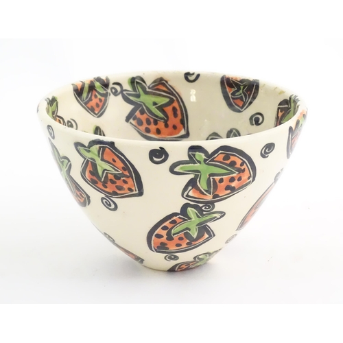 166 - A studio pottery jug and bowl decorated with hand painted strawberry detail by Liz Riley. Marked und... 