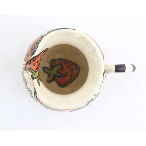 166 - A studio pottery jug and bowl decorated with hand painted strawberry detail by Liz Riley. Marked und... 