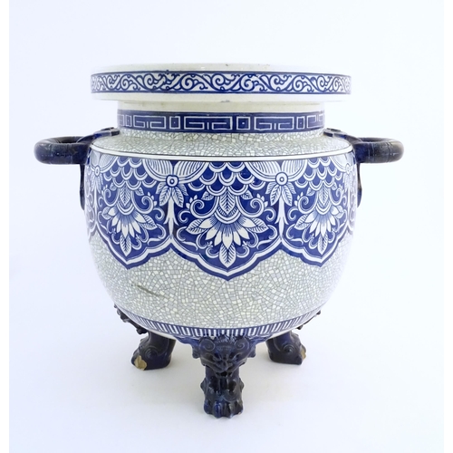 171 - A large Victorian Minton blue and white jardiniere / planter with twin handles standing on four feet... 