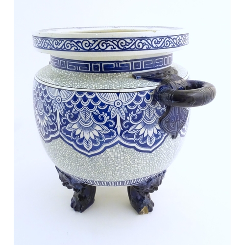 171 - A large Victorian Minton blue and white jardiniere / planter with twin handles standing on four feet... 