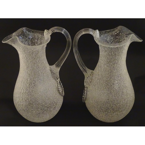 222 - A pair of late 19thc / early 20thC lemonade / Kalte Ente jugs. The crackle glass jugs with loop hand... 