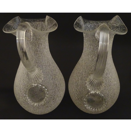 222 - A pair of late 19thc / early 20thC lemonade / Kalte Ente jugs. The crackle glass jugs with loop hand... 