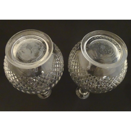 223 - A pair of late 19thC / early 20thC glass decanters and stoppers with cut decoration. Approx 14