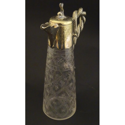 227 - A cut glass claret jug with cut decoration and silver plate mounts, the handle formed as entwined sn... 