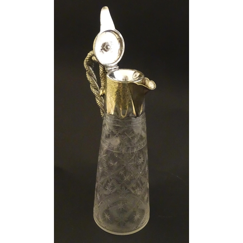 227 - A cut glass claret jug with cut decoration and silver plate mounts, the handle formed as entwined sn... 